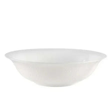 White shallow serving bowl with textured exterior and smooth interior.