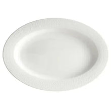 White round serving plate with textured rim and smooth center.