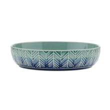 Shallow stoneware bowl in teal with blue chevron pattern across the front