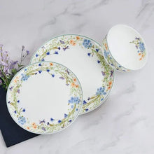 Floral bone china dinner plate set with white interior and multicolor flower-and-vine border