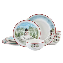 Snowman dinnerware set with round plates and bowls featuring red trim and snowy forest scene