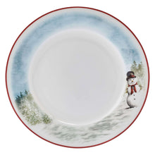 Round dinner plate with red rim, white center, blue sky, and snowman beside snowy trees