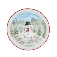 Round dinner plate with red edge and a snowman in a snowy forest under blue sky