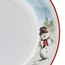 Dinner plate rim detail with red trim and a standing snowman in a winter scene