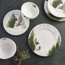 Mikasa Snowman dinnerware set shown from above, with matching plates and bowls
