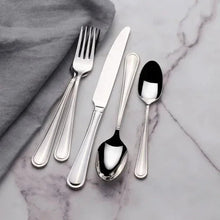 Stainless steel flatware set with forks, spoon, and knife, polished