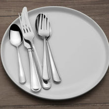 Stainless steel flatware set with fork, knife, and spoon on a plate