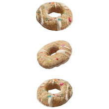 Three ring-shaped vanilla-glazed dog biscuits with colorful sprinkles