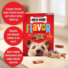 Milk-Bone Flavor Snacks dog biscuits pack with bone-shaped biscuits on wooden floor