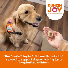 Vanilla glaze dog treat biscuit held near golden retriever, Milk-Bone Dunkin Joy