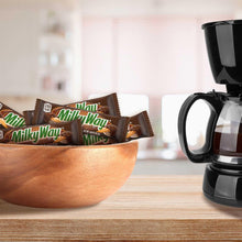 MilkyWay milk chocolate candy bars in wrappers stacked on a counter