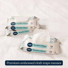 Multiple baby sensitive wipes packs with 0% fragrance labels on a white surface