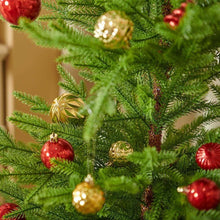 Close-up of red and gold glitter Christmas baubles with faceted patterns