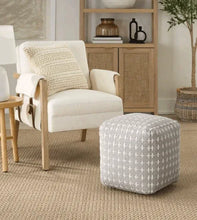 Patterned ottoman pouf in grey with white cross design, rounded square seat