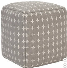 Gray pouf with repeating white cross motif and rounded top