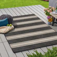 Outdoor area rug with black and ivory horizontal stripe pattern, rectangular border.