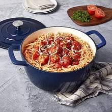 7-qt enameled cast iron Dutch oven, navy blue body with matching lid and curved handles