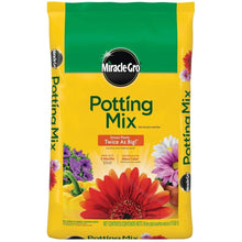 Miracle-Gro potting mix bag with green top, yellow bag, and flower graphics