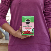 Miracle-Gro Rose Plant Food box held in a person’s hands