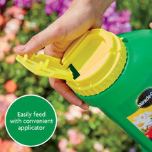 Green plant food jug with yellow cap being opened, applicator visible
