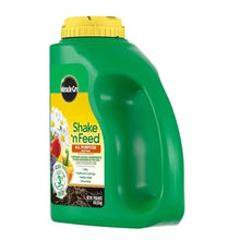 Miracle-Gro Shake 'n Feed plant food jug, green body, yellow cap, side view