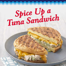 Miracle Whip creamy spread on tuna sandwich halves with yellow filling