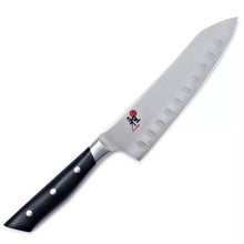 Miyabi Evolution Santoku knife with dark handle and light blade, scalloped edge