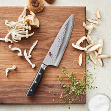 8-inch chef knife with hammered Damascus blade and black handle, chef-style