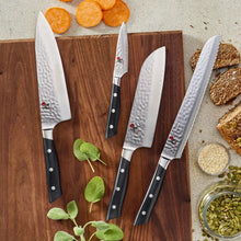Three chef knives with Damascus-pattern blades and black handles