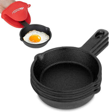 Mini cast iron skillet with a sunny-side-up egg and a red silicone mitt on top