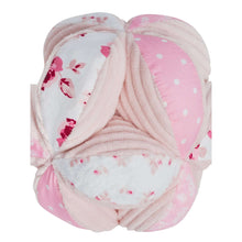 Pink and white plush sensory ball with rose print petals and braided seam details