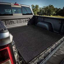 Black rubber cargo mat fitted in a pickup truck bed for protection