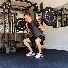 Black rubber mat on gym floor beneath a lifter during strength training