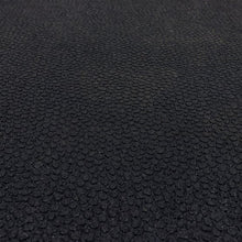 Close-up of black rubber mat texture with pebbled, raised pattern