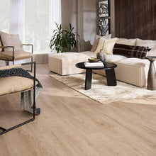 Light oak-toned wood plank laminate flooring in a living room setting
