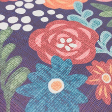 Floral kitchen mat detail with pink flower motif on deep blue-purple background