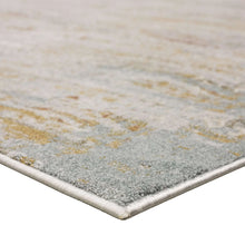 Light gray and beige area rug corner with distressed speckled pattern