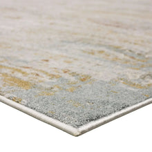 Abstract area rug close-up in gray and ivory with stitched corner edge