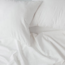 White sheet fabric with folded edge and visible corner seam