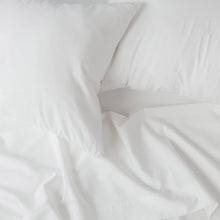 White bedsheet fabric with crisp folds and smooth weave, close-up detail