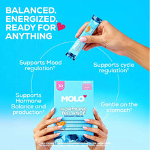 Hands holding Hormone Balance 30-pack box and sweet orange stick pack