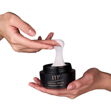 Firming cream jar in hands with white cream dollop on skin