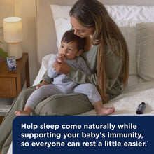 Mother holding baby on a couch with on-screen message about sleep support and immunity