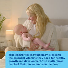 Mother holding a baby while breastfeeding in a cozy room