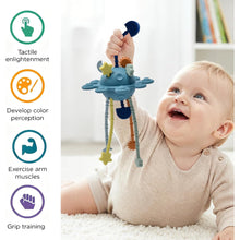 Blue pull-string sensory toy being held by a baby, with rotating arms.
