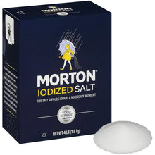 Iodized salt carton side with food service badge and 4 lb net wt, next to salt mound