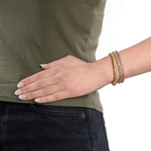 Triple bracelet stack on wrist: gold, rose, and silver-tone mosaic chain bangles