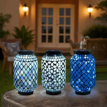 Set of three mosaic solar lanterns in blue and white tile patterns with black bases