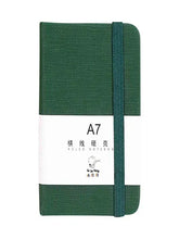 Green A7 pocket notebook with hard cover and elastic closure strap