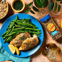 Garlic & herb seasoning bottle beside chicken, asparagus, and lemon
